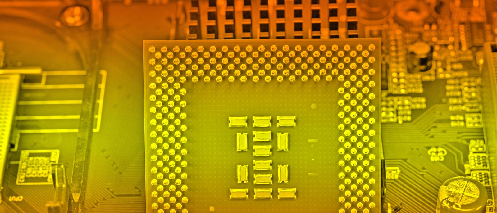 Close-up of a microprocessor chip on a green circuit board
