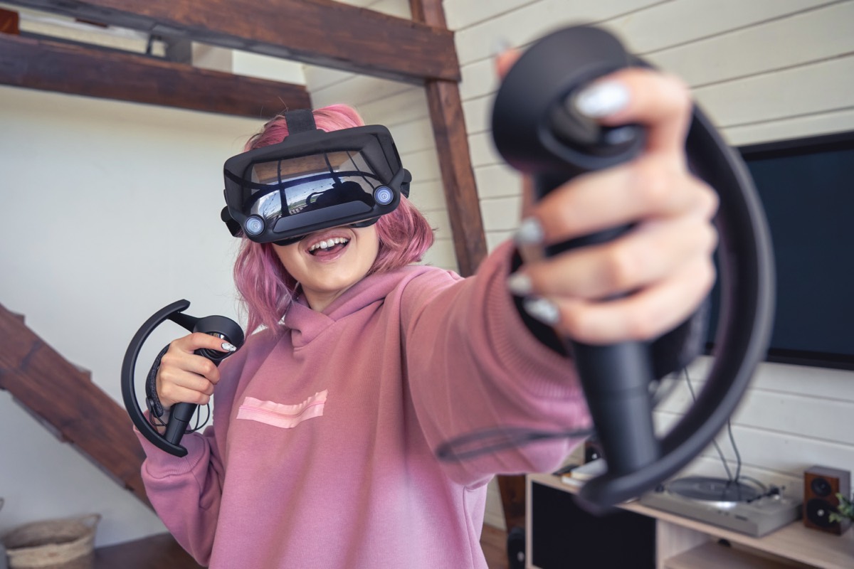A person gripping a vibrating video game controller during play