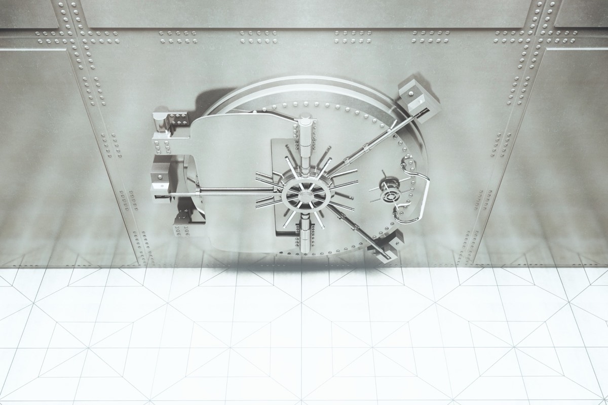A locked vault door beside a stamped patent certificate