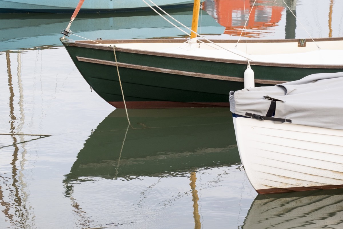 Two power boats moored side by side at a marina dock