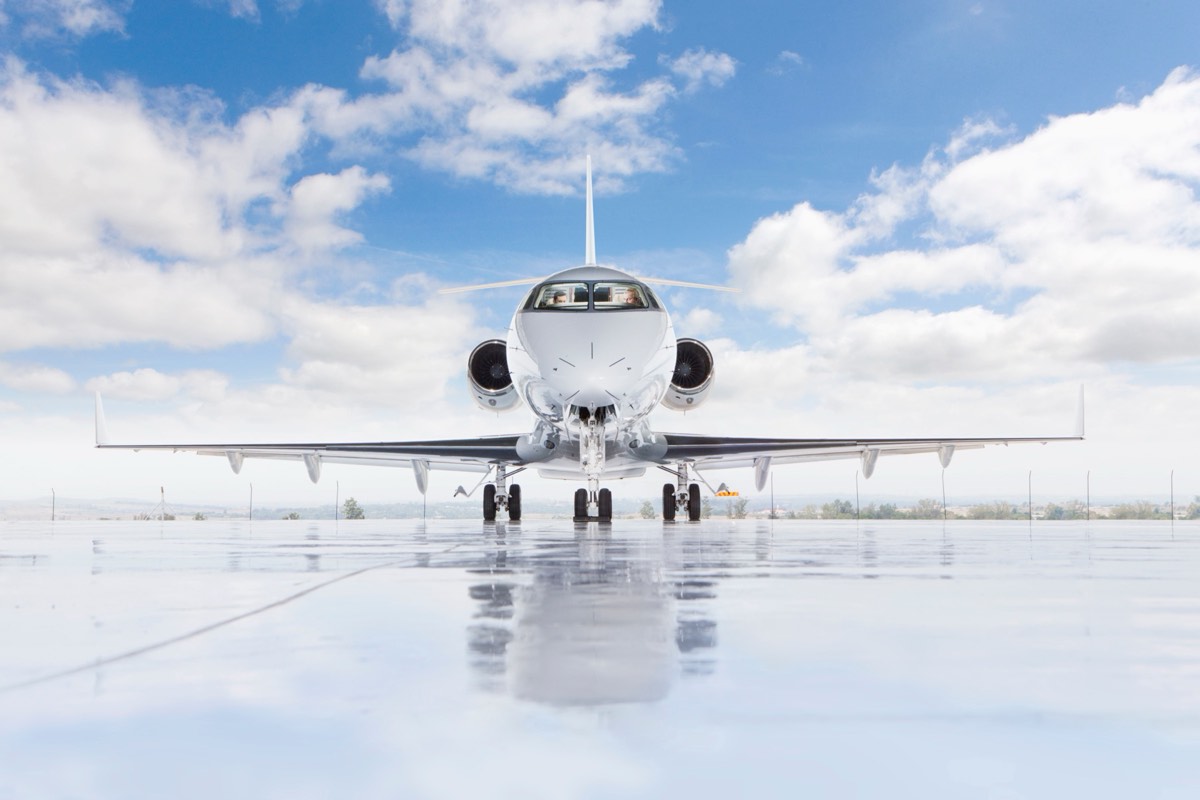 Small chartered aircraft parked on a regional airport tarmac