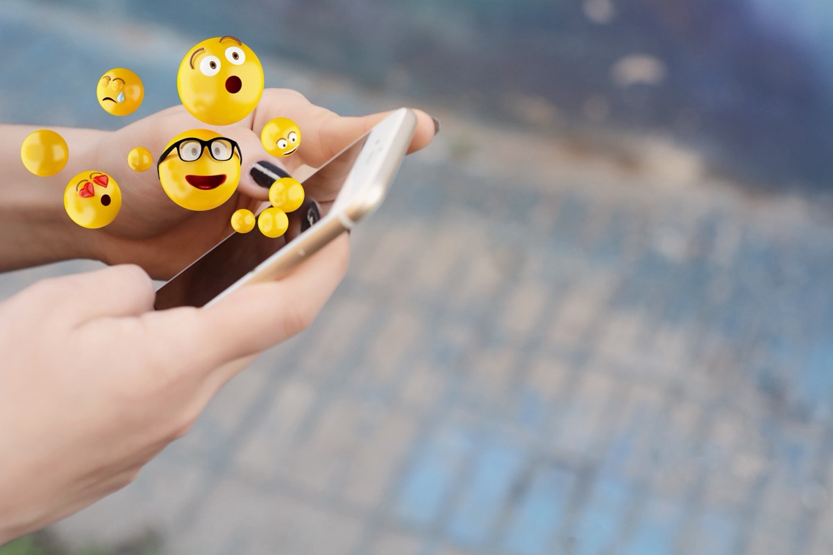 Smartphone displaying a messaging app with animated emoji characters
