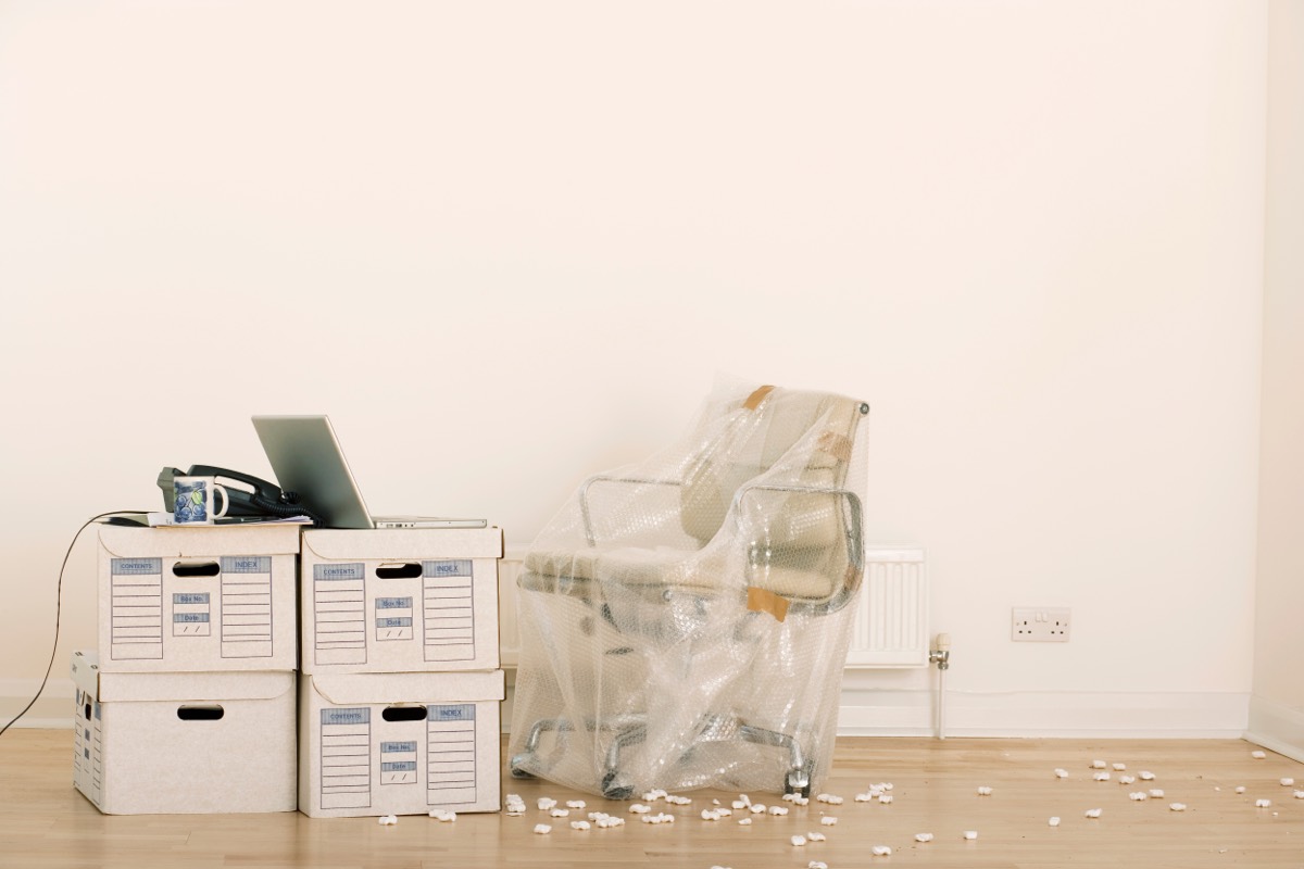 Stacked cardboard file boxes on an office desk after hours