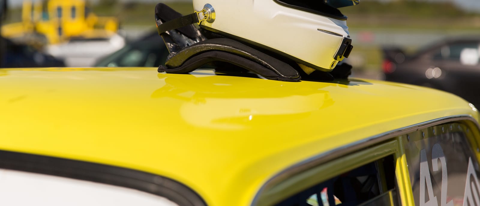 A self-driving car's spinning lidar sensor mounted on a vehicle roof at dusk
