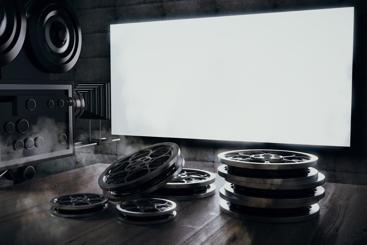 Vintage movie posters and lobby cards displayed on a theater wall