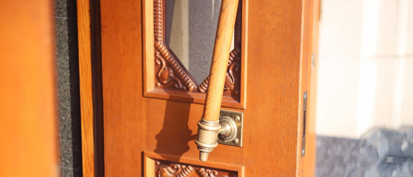 A row of polished brass door locks and deadbolts on a hardware store display