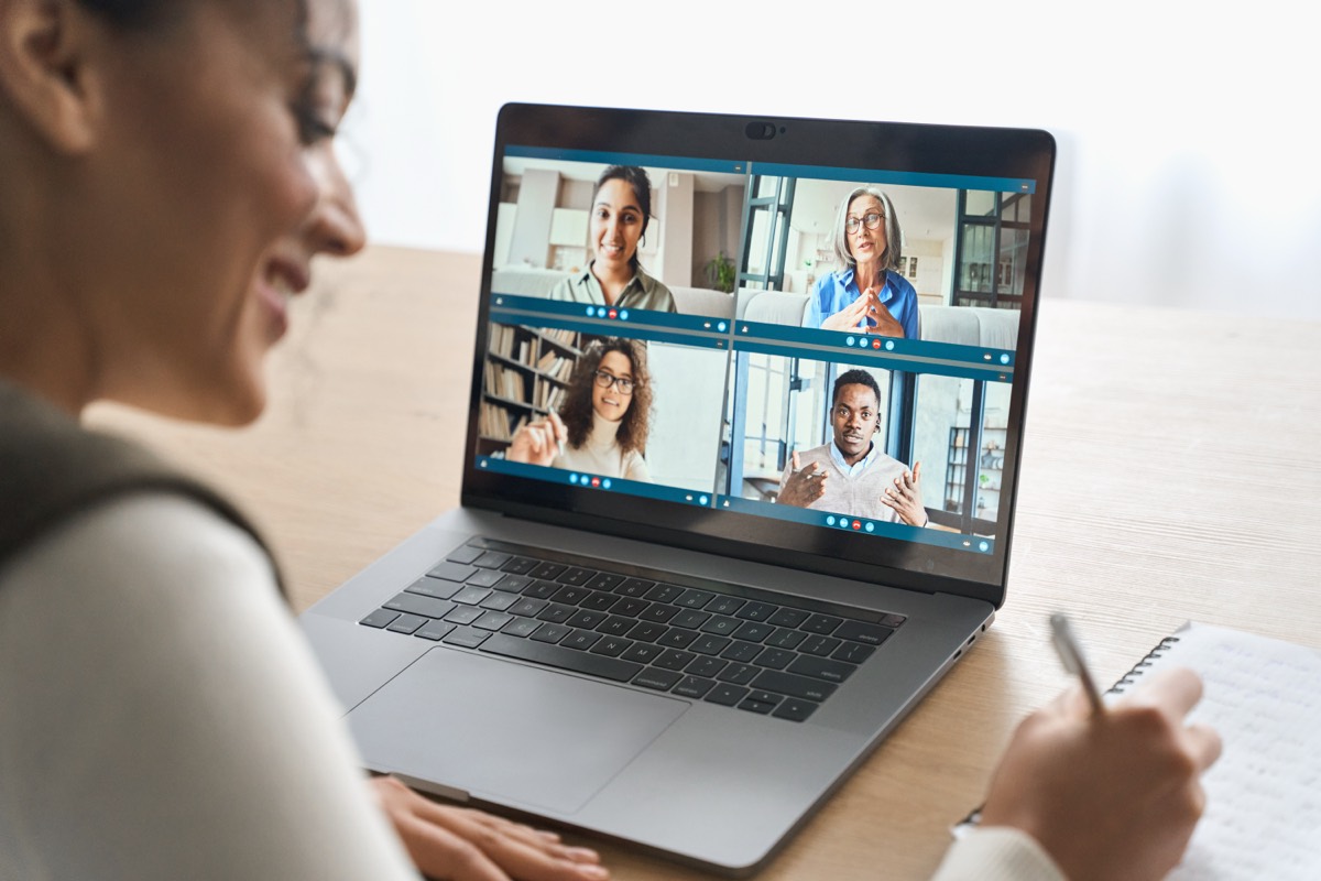 A laptop displaying a virtual classroom with participant video tiles
